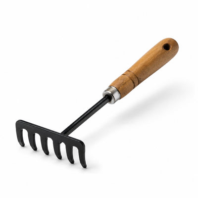 Garden rake with wooden handle on a white background
