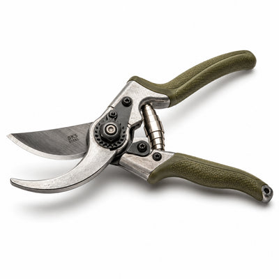 Gardening pruner with green handle on a white background