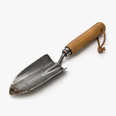Gardening trowel with wooden handle on a white background